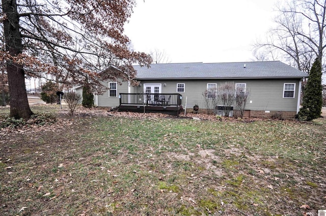 rear view of property featuring a yard and a deck