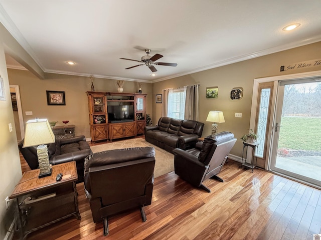 living room with crown molding, hardwood / wood-style flooring, and ceiling fan