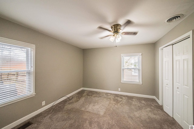 unfurnished bedroom with carpet floors, ceiling fan, and a closet