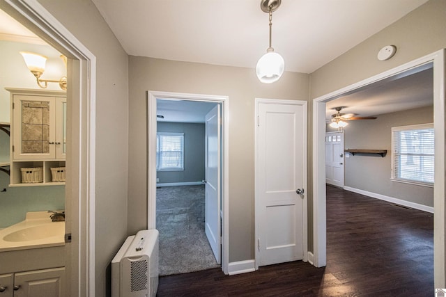 bathroom with ceiling fan, radiator heating unit, wood-type flooring, and vanity