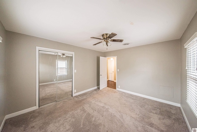 unfurnished bedroom with a closet, ceiling fan, and carpet flooring