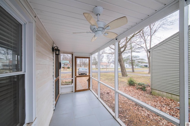 unfurnished sunroom featuring ceiling fan