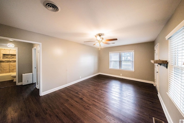 unfurnished room featuring dark wood-type flooring and ceiling fan