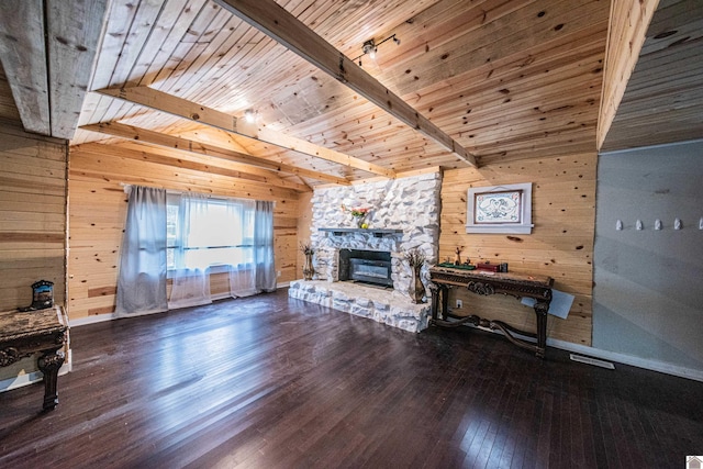 living room with wood walls, wood ceiling, beamed ceiling, a fireplace, and hardwood / wood-style floors