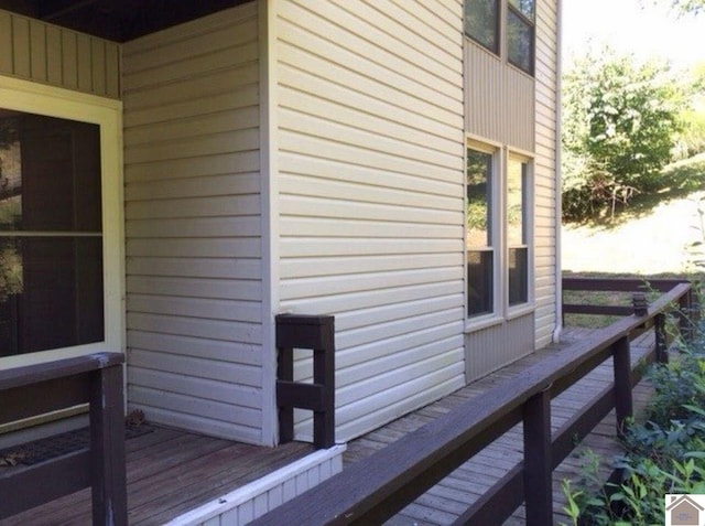 view of side of home with a wooden deck