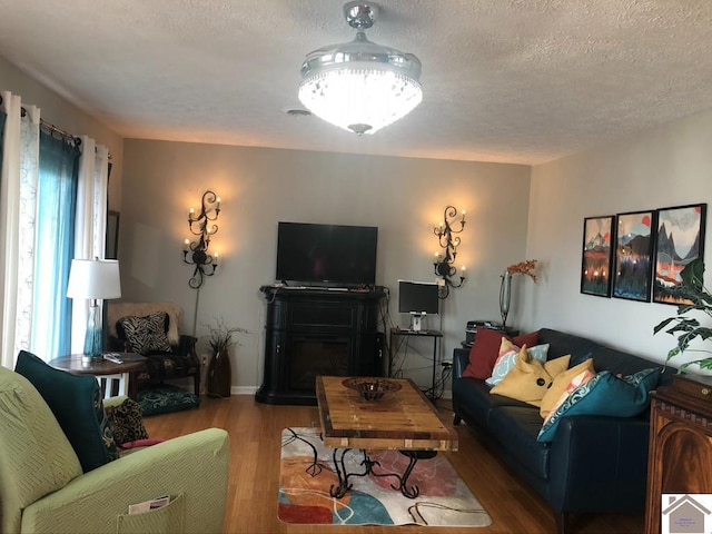 living room featuring hardwood / wood-style flooring and a textured ceiling