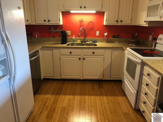 kitchen featuring white cabinetry, white appliances, sink, and light wood-type flooring