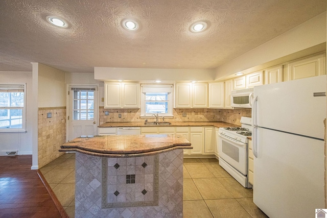 8200 Houser Rd, Boaz, Mccracken, KY 42027 - kitchen with white appliances, a center island, sink, and white cabinets
