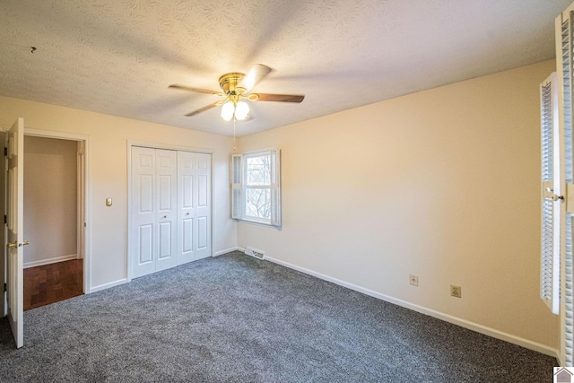8200 Houser Rd, Boaz, Mccracken, KY 42027 - unfurnished bedroom with ceiling fan, a closet, dark carpet, and a textured ceiling