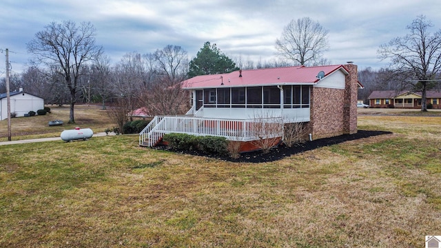 8200 Houser Rd, Boaz, Mccracken, KY 42027 - rear view of property with a sunroom and a lawn