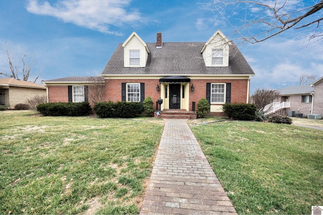 cape cod home featuring central AC and a front yard