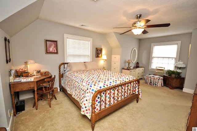 carpeted bedroom featuring a textured ceiling, vaulted ceiling, and ceiling fan