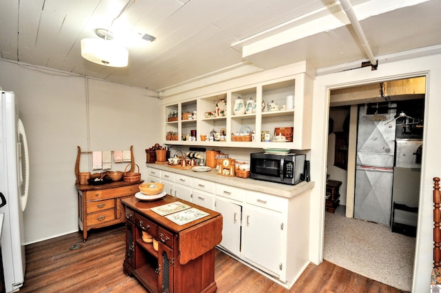 kitchen featuring white refrigerator, dark hardwood / wood-style floors, and white cabinets