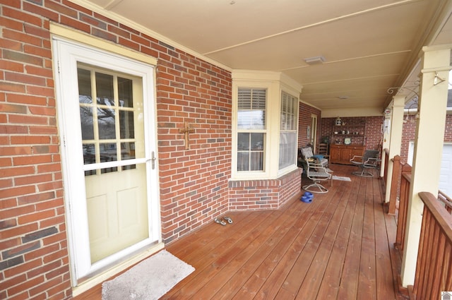 wooden terrace featuring covered porch