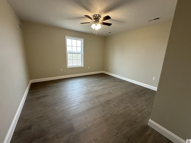 empty room with dark wood-type flooring and ceiling fan