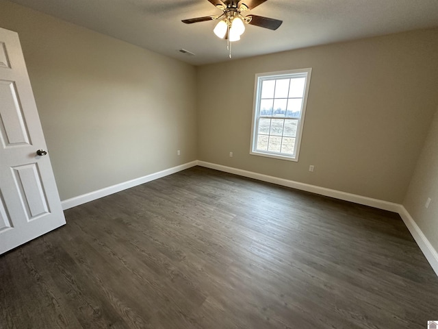 unfurnished room featuring ceiling fan and dark hardwood / wood-style flooring