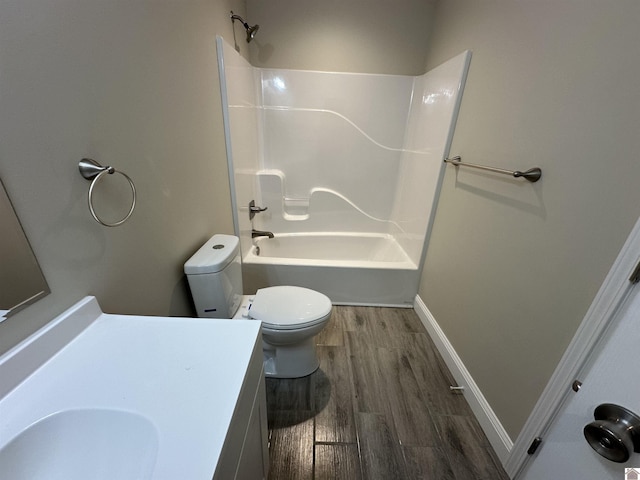 full bathroom featuring hardwood / wood-style flooring, vanity, toilet, and bathing tub / shower combination