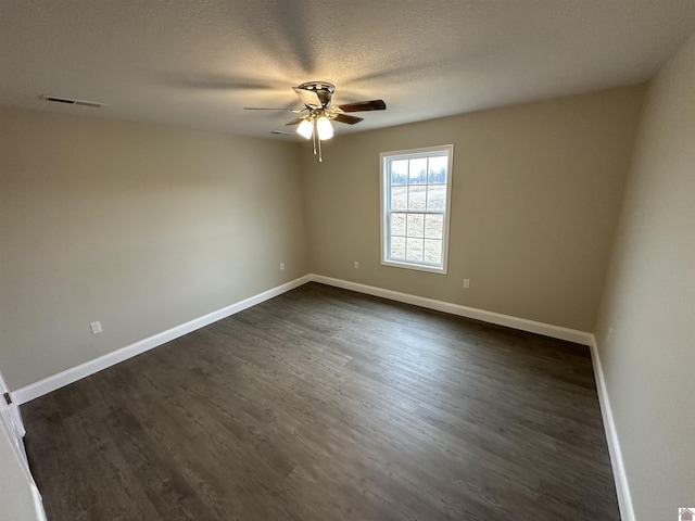 spare room with ceiling fan, dark hardwood / wood-style floors, and a textured ceiling