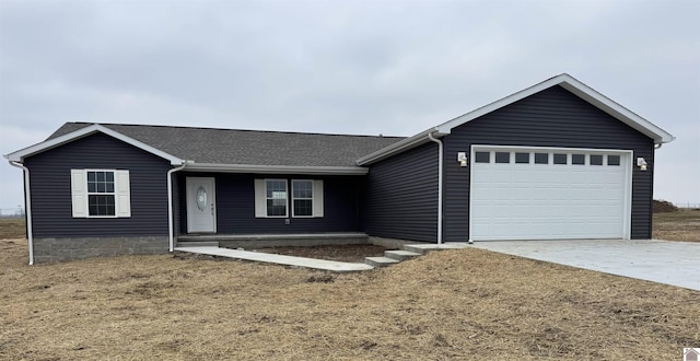 ranch-style home featuring a garage and a front yard