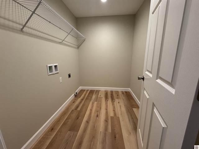 laundry room with hookup for a washing machine, hookup for an electric dryer, and light wood-type flooring