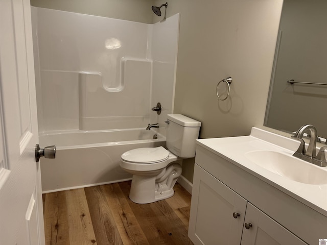 full bathroom featuring vanity, hardwood / wood-style flooring, shower / bathtub combination, and toilet