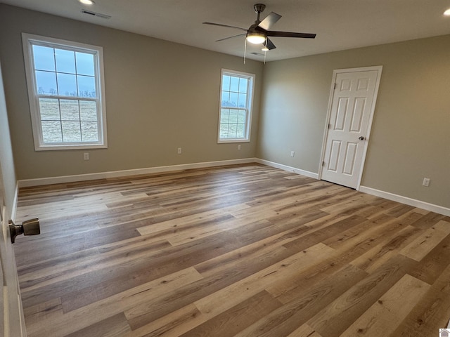 spare room featuring ceiling fan and light wood-type flooring