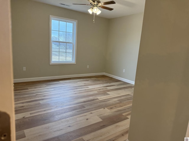 empty room featuring ceiling fan and light wood-type flooring