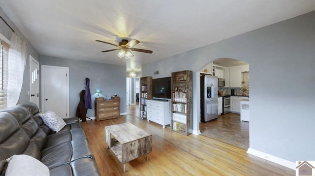 living room featuring light hardwood / wood-style flooring and ceiling fan