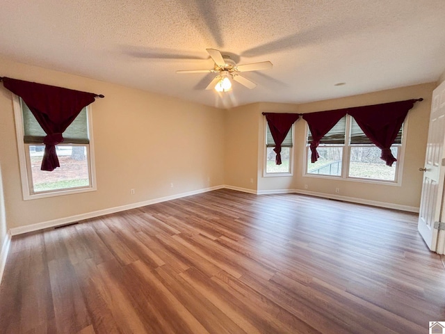 unfurnished room featuring ceiling fan, hardwood / wood-style flooring, and a textured ceiling