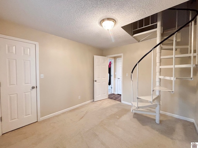 basement featuring carpet floors and a textured ceiling