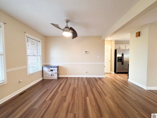 unfurnished room with ceiling fan, a textured ceiling, and light hardwood / wood-style floors