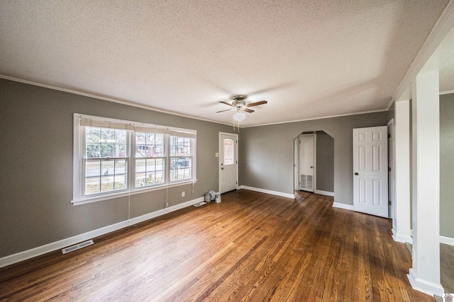 empty room with crown molding, ceiling fan, dark hardwood / wood-style floors, and a textured ceiling