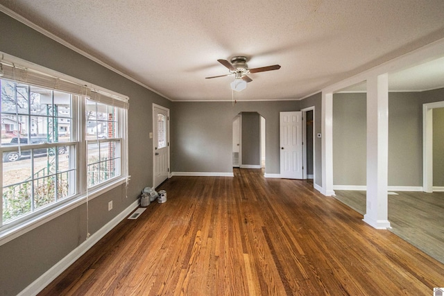 spare room with crown molding, ceiling fan, a textured ceiling, and dark hardwood / wood-style flooring