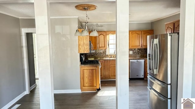 kitchen featuring crown molding, stainless steel appliances, and dark hardwood / wood-style floors