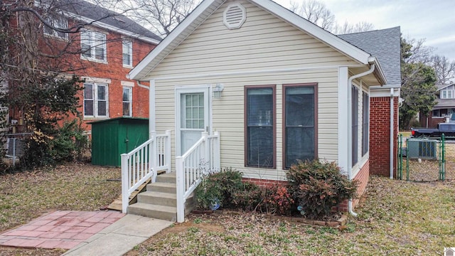 view of front of house featuring a storage unit