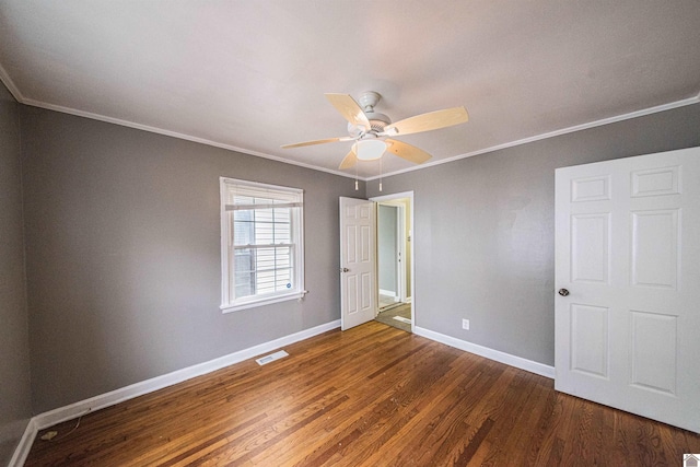 unfurnished bedroom featuring crown molding, ceiling fan, and dark hardwood / wood-style flooring