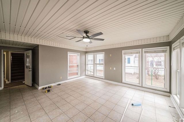 tiled spare room featuring ceiling fan