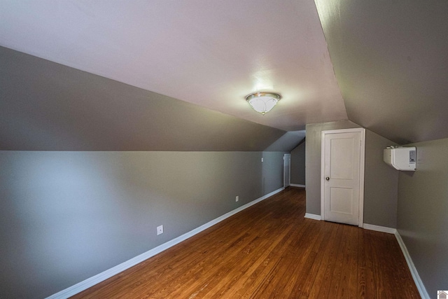 bonus room featuring dark wood-type flooring and vaulted ceiling