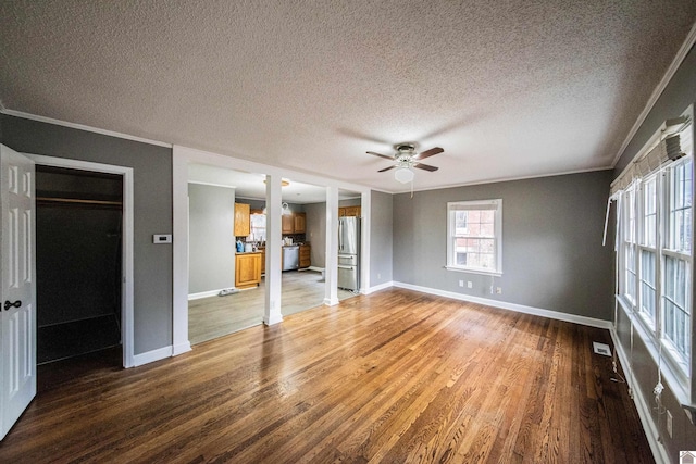 interior space with hardwood / wood-style flooring, ceiling fan, crown molding, and a textured ceiling