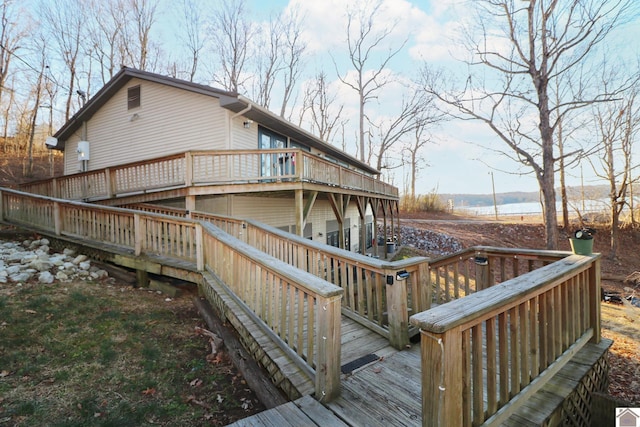 wooden terrace featuring a water view