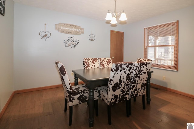 dining area with an inviting chandelier and hardwood / wood-style floors