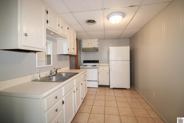 kitchen featuring a paneled ceiling, sink, white cabinets, light tile patterned floors, and white appliances