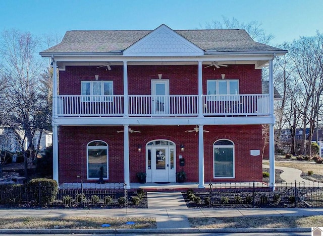 view of front of property featuring ceiling fan, a balcony, and french doors