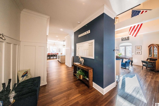 hallway with a wealth of natural light, ornamental molding, and dark hardwood / wood-style floors