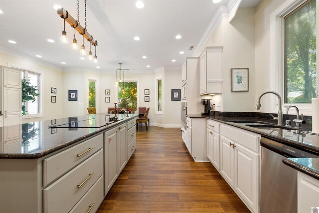 502 N 5th St, Paducah, KY 42001 - kitchen with appliances with stainless steel finishes, a sink, a center island, ornamental molding, and white cabinets