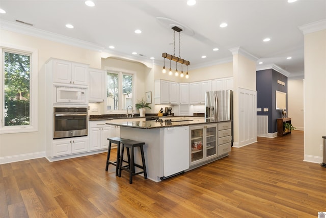 502 N 5th St, Paducah, KY 42001 - kitchen with appliances with stainless steel finishes, ornamental molding, beverage cooler, dark wood-style floors, and a center island