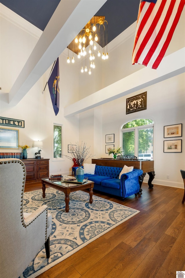 502 N 5th St, Paducah, KY 42001 - living area featuring a high ceiling, a chandelier, plenty of natural light, wood finished floors, and baseboards