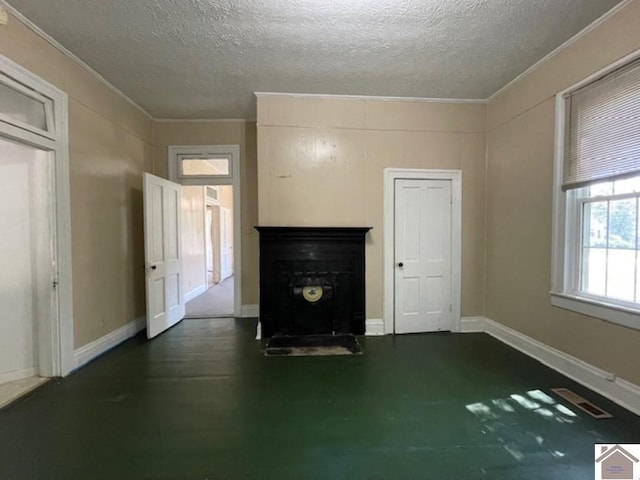 unfurnished living room with ornamental molding and a textured ceiling