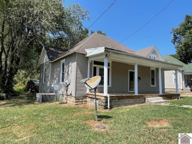 view of front of house with a porch and a front yard