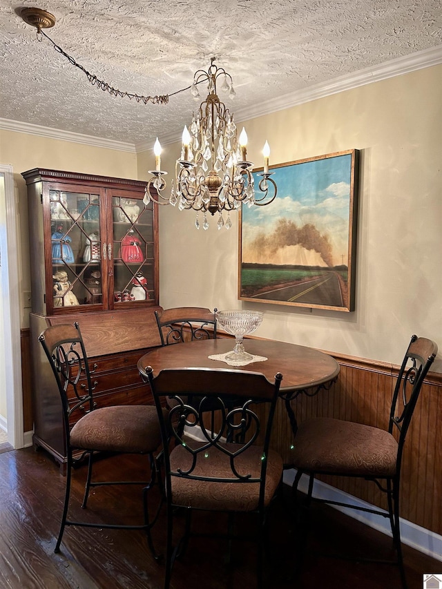 dining area featuring crown molding, dark wood-type flooring, and a textured ceiling